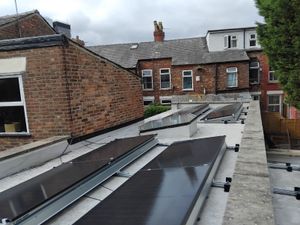 Completed solar panels mounted on flat roof with rails