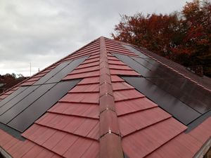 Solar panels installed on a red tile roof