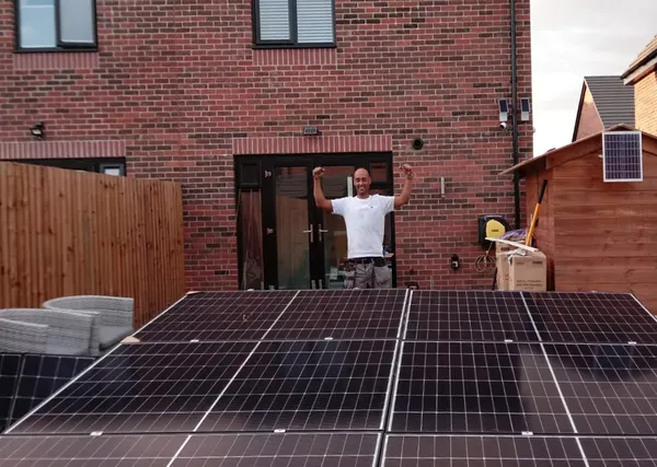 Ashley Merritt on site alongside a ground-mounted solar array