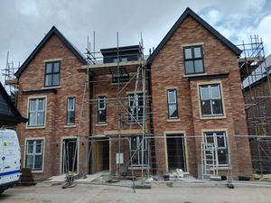 New build houses under construction with solar panel installation