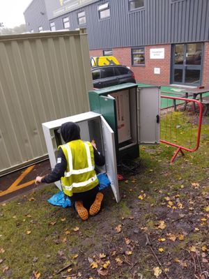 Installer working on commercial solar installation with delivery van