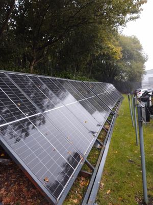 Large commercial solar panel array on flat roof installation