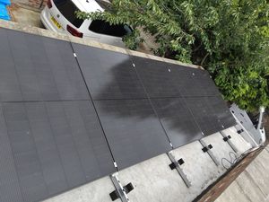 Black solar panels installed on flat roof in Rushholme