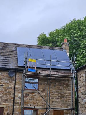 Solar panels being installed on a traditional Manchester slate roof