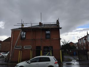 Scaffolding setup for solar installation on brick building in Failsworth