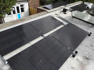 Completed flat roof solar installation on commercial building
